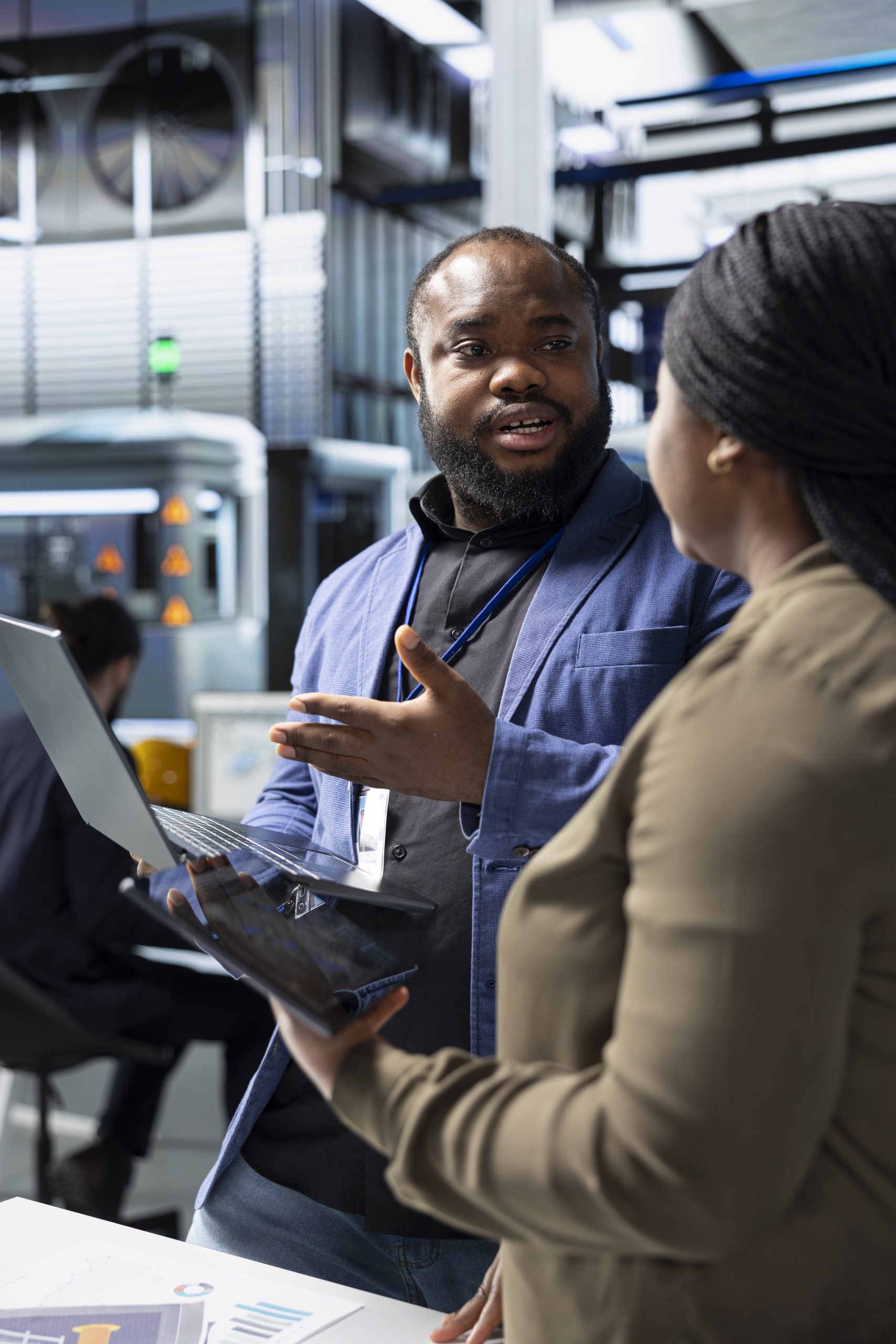 African american team of energy consultants analyzing insight in solar panel plant, ensuring high standards in renewable energy production line, quality control and manufacturing efficiency.